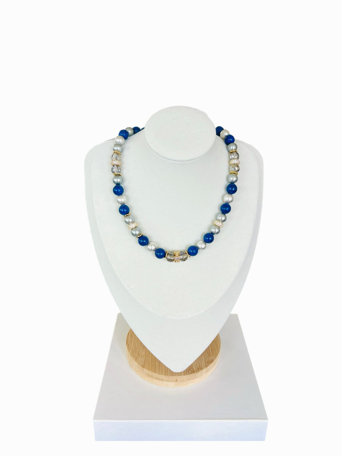 The Celine Necklace on a white display bust