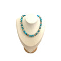 The Andrea Necklace — turquoise with Austrian crystals and gold beads, on a white display bust