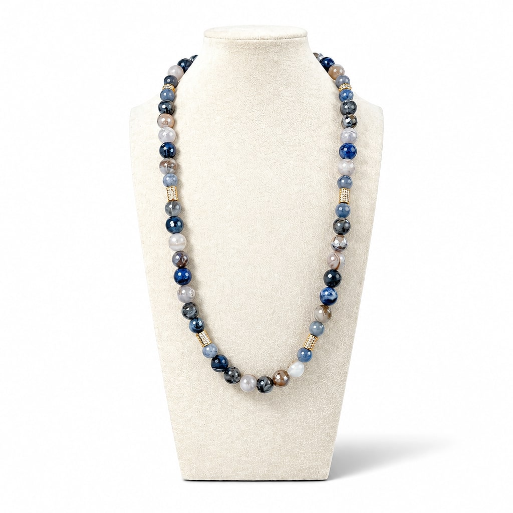 The Carolina Necklace on a display bust: a long strand of blue, grey and brown agate with gold pavé beads