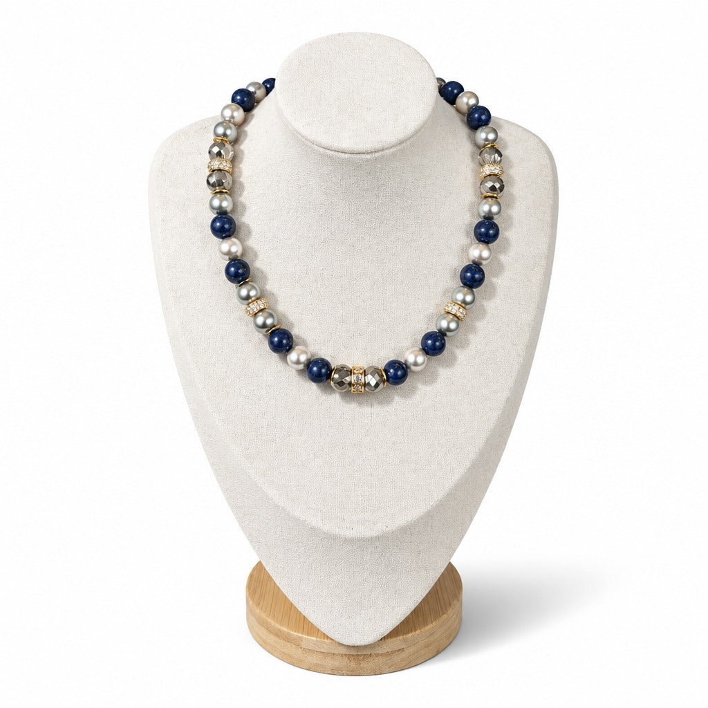 The Celine Necklace on a display bust: blue lapis lazuli with silver and white pearls, Austrian crystals and gold crystal rondelles