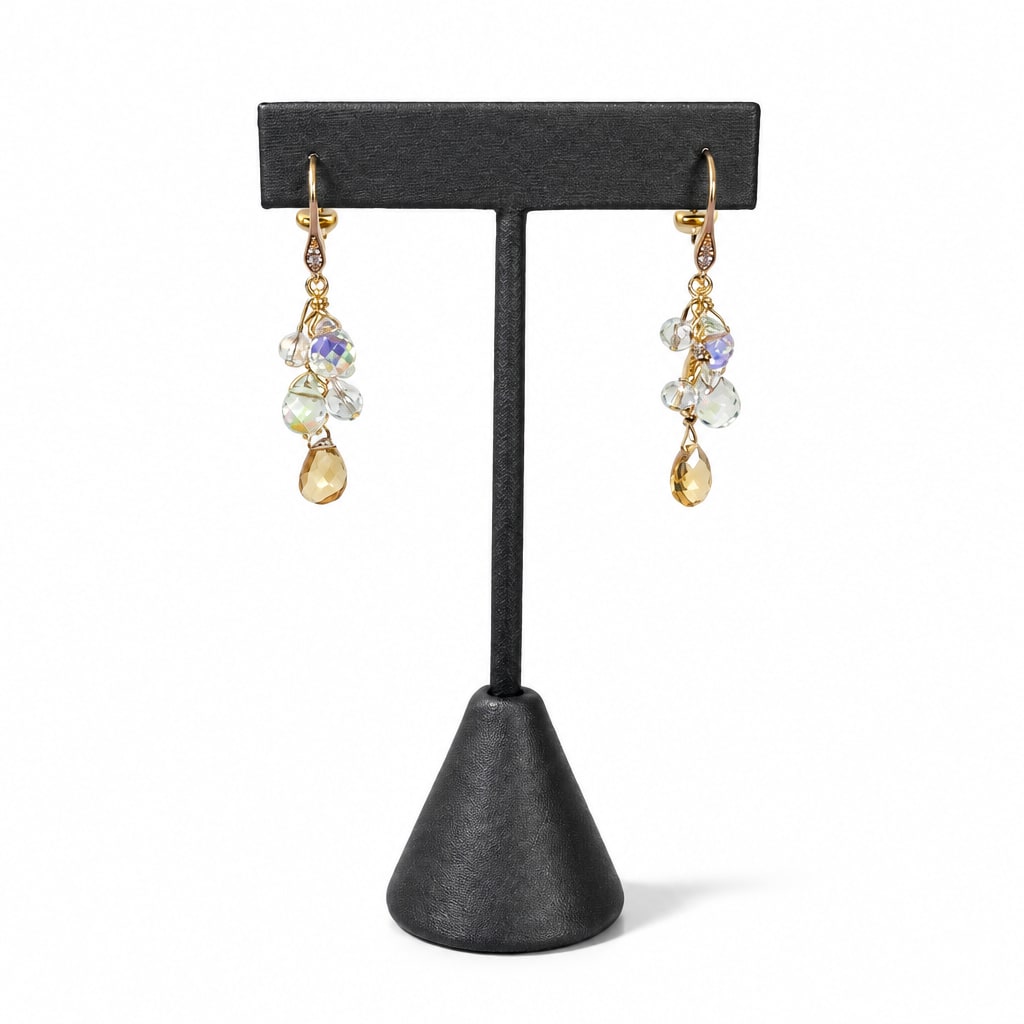 Citrine & Clear Crystal Drop Earrings on a dark earring stand: a cascade of clear crystals above a faceted citrine drop, gold throughout