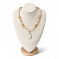 The Kimberly Necklace on a display bust: luminous white glass pearls with champagne crystals, gold accents and a baroque pearl pendant