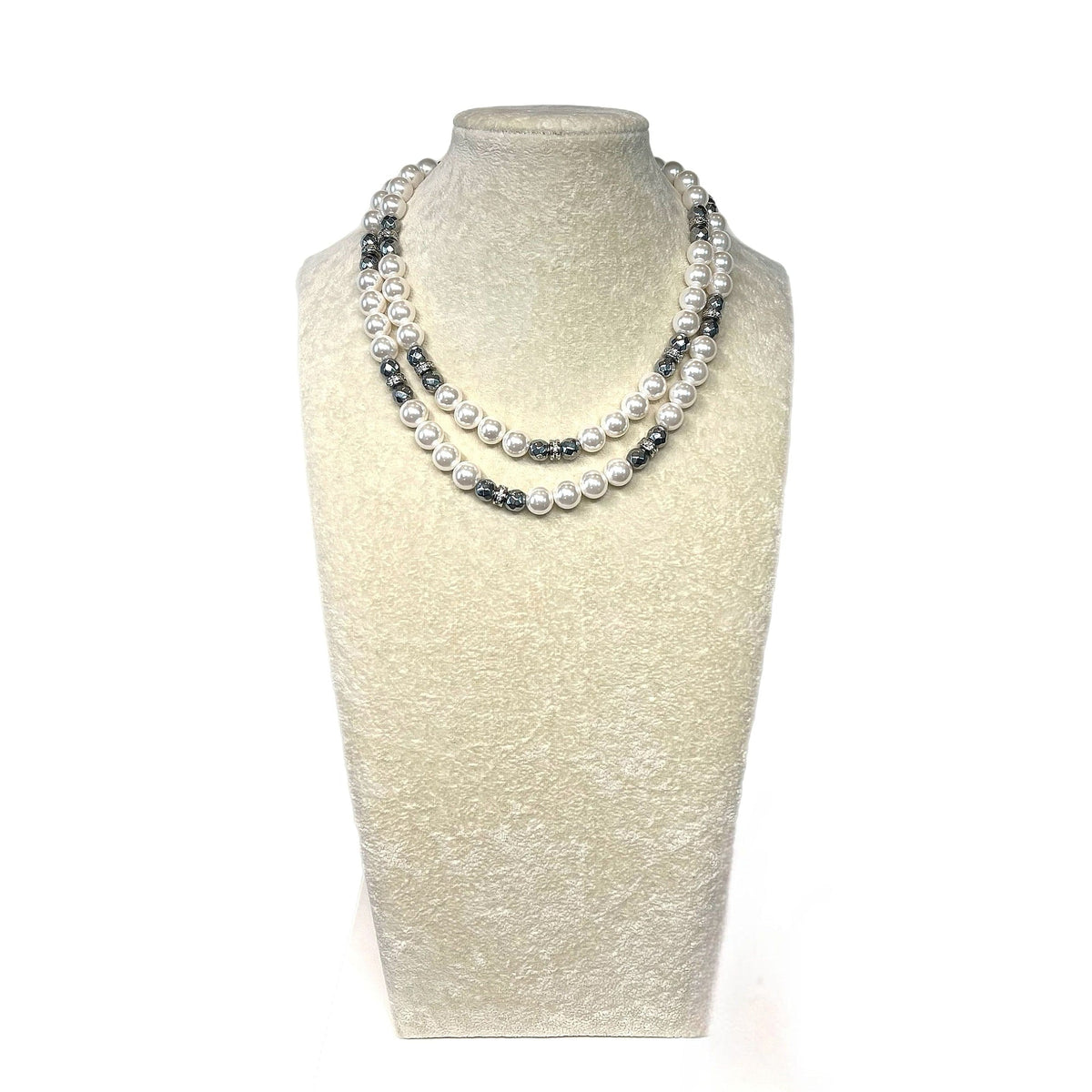 The Marilyn Necklace on a display bust: a long double strand of luminous white glass pearls with plated hematite rondelles