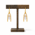 Moonstone & Pearl Drop Earrings — moonstone and glass pearls in a gold chain cradle, on a bronze earring stand