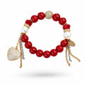 Red Jade & Glass Pearl Bracelet with a pavé heart charm: 12 mm red jade beads with two white glass pearls, two faceted red crystals, a pavé ball, gold and silver chains and the Bijoux Affair tag