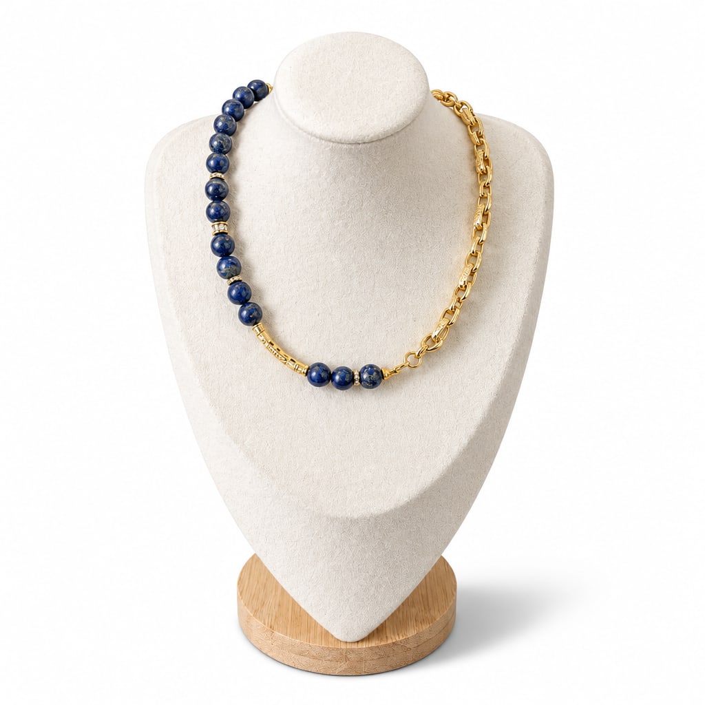Sodalite necklace on a display bust: a long run of deep blue beads on one side, a gold link chain on the other
