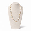 The Valina Necklace on a display bust: white howlite and shell beads with speckled natural stones and gold pavé accents