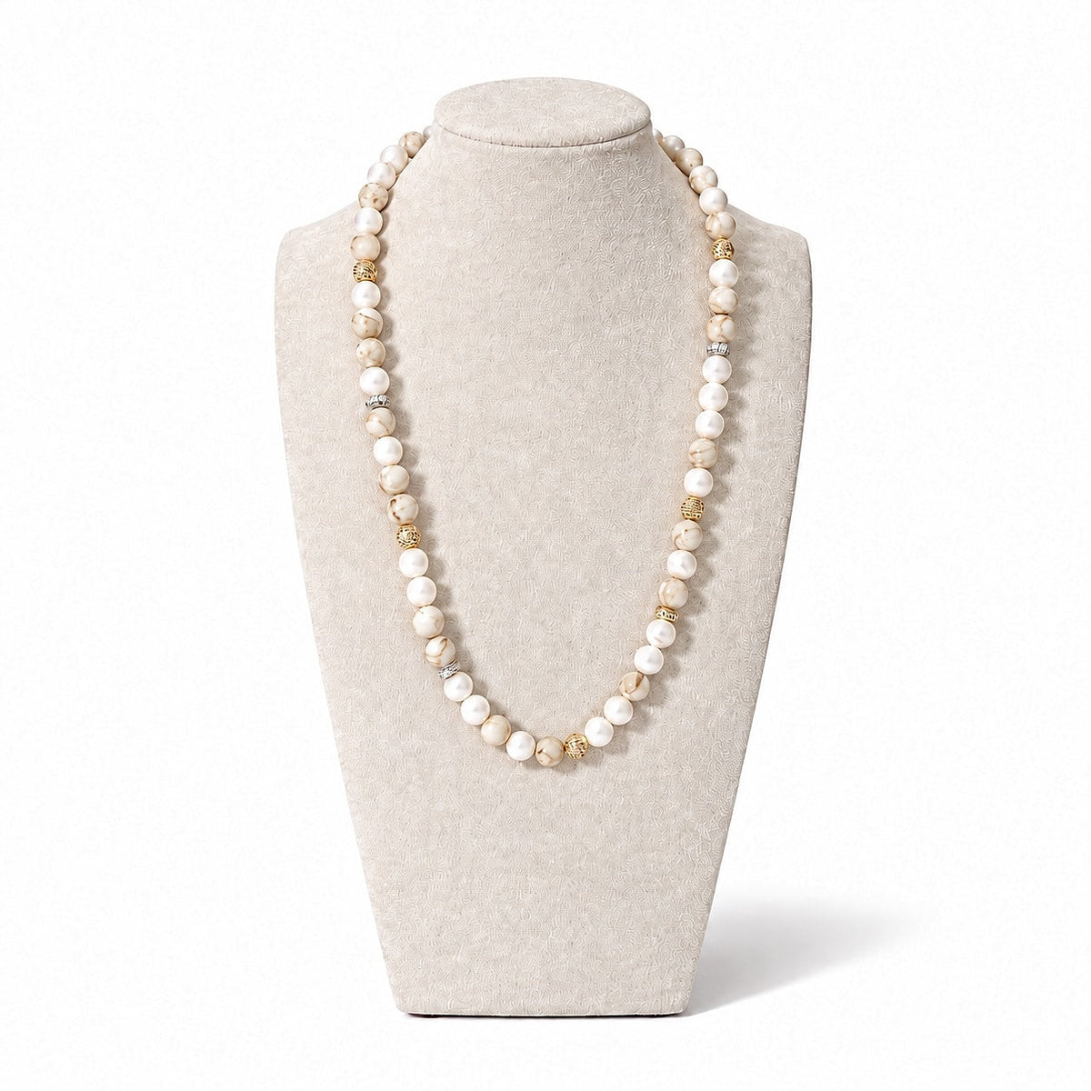 The Valina Necklace on a display bust: white howlite and shell beads with speckled natural stones and gold pavé accents